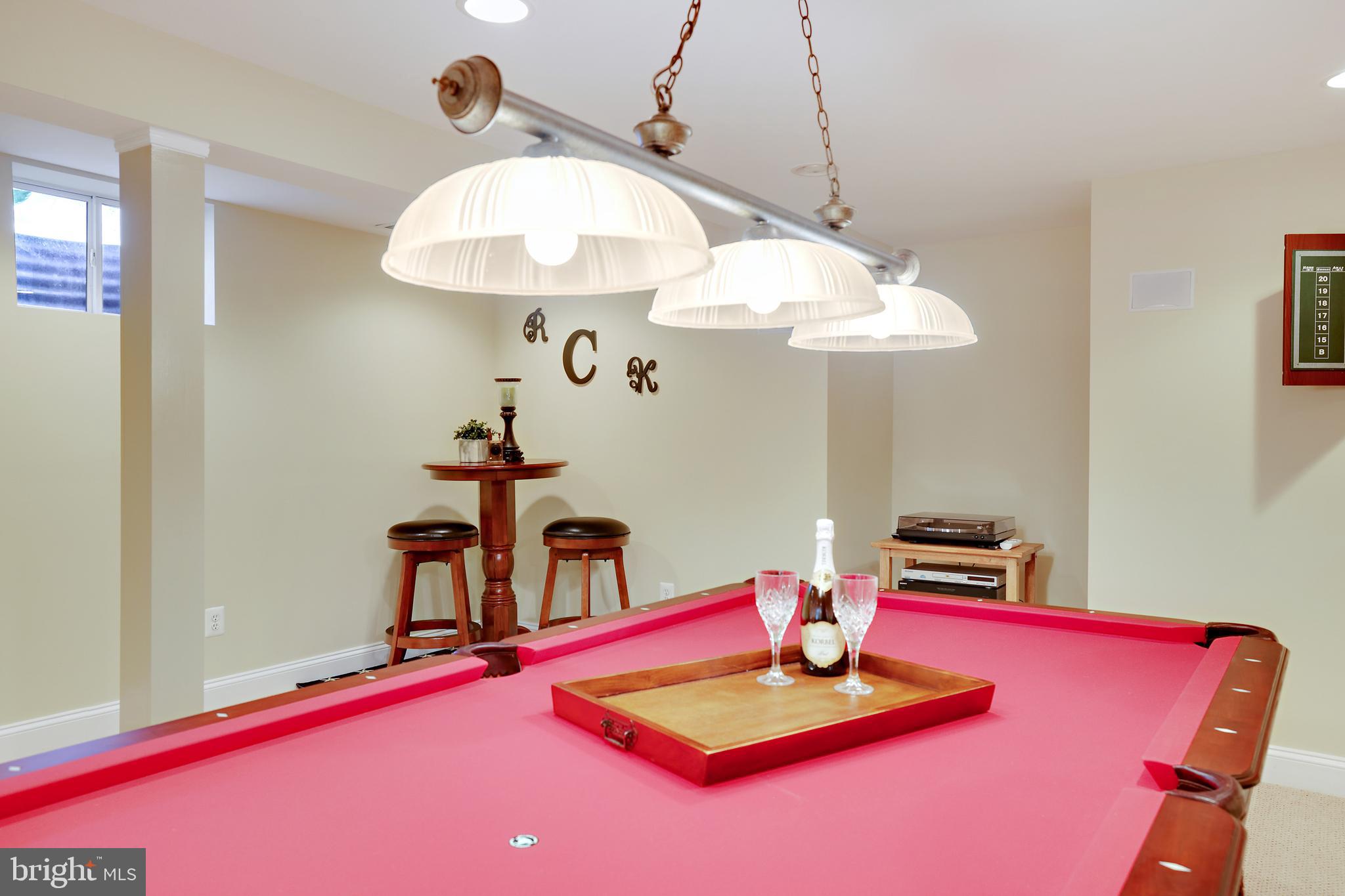 8301 Banister Road Severn, MD 21144 - Photo 52 of 57 a living room with dining table and a chandelier
