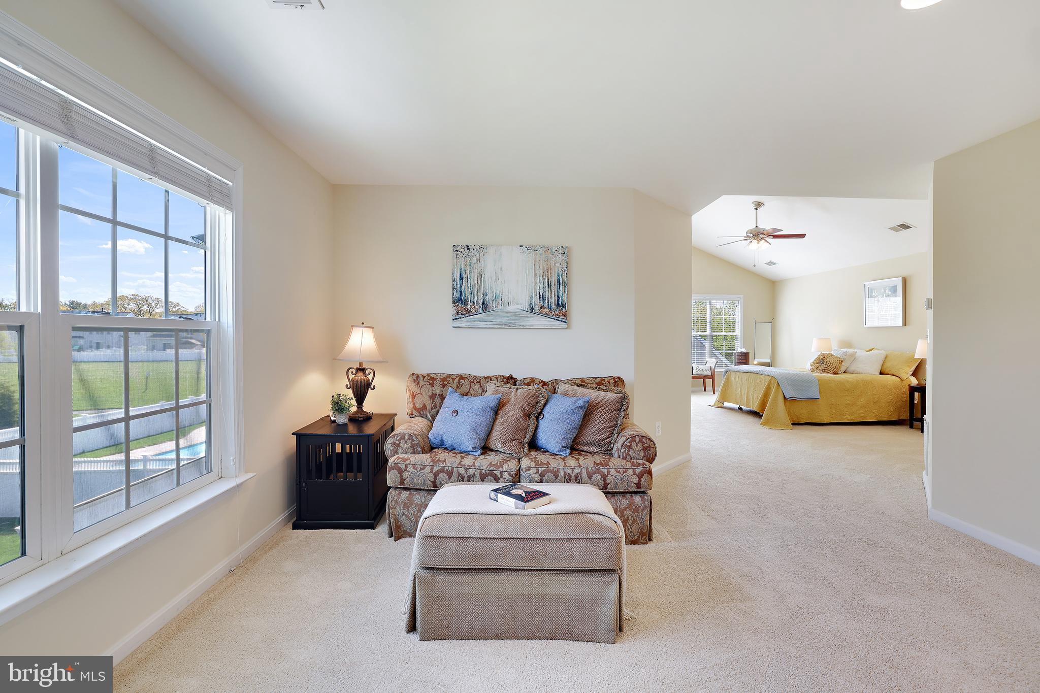 8301 Banister Road Severn, MD 21144 - Photo 7 of 57 a living room with furniture a large window and a chandelier