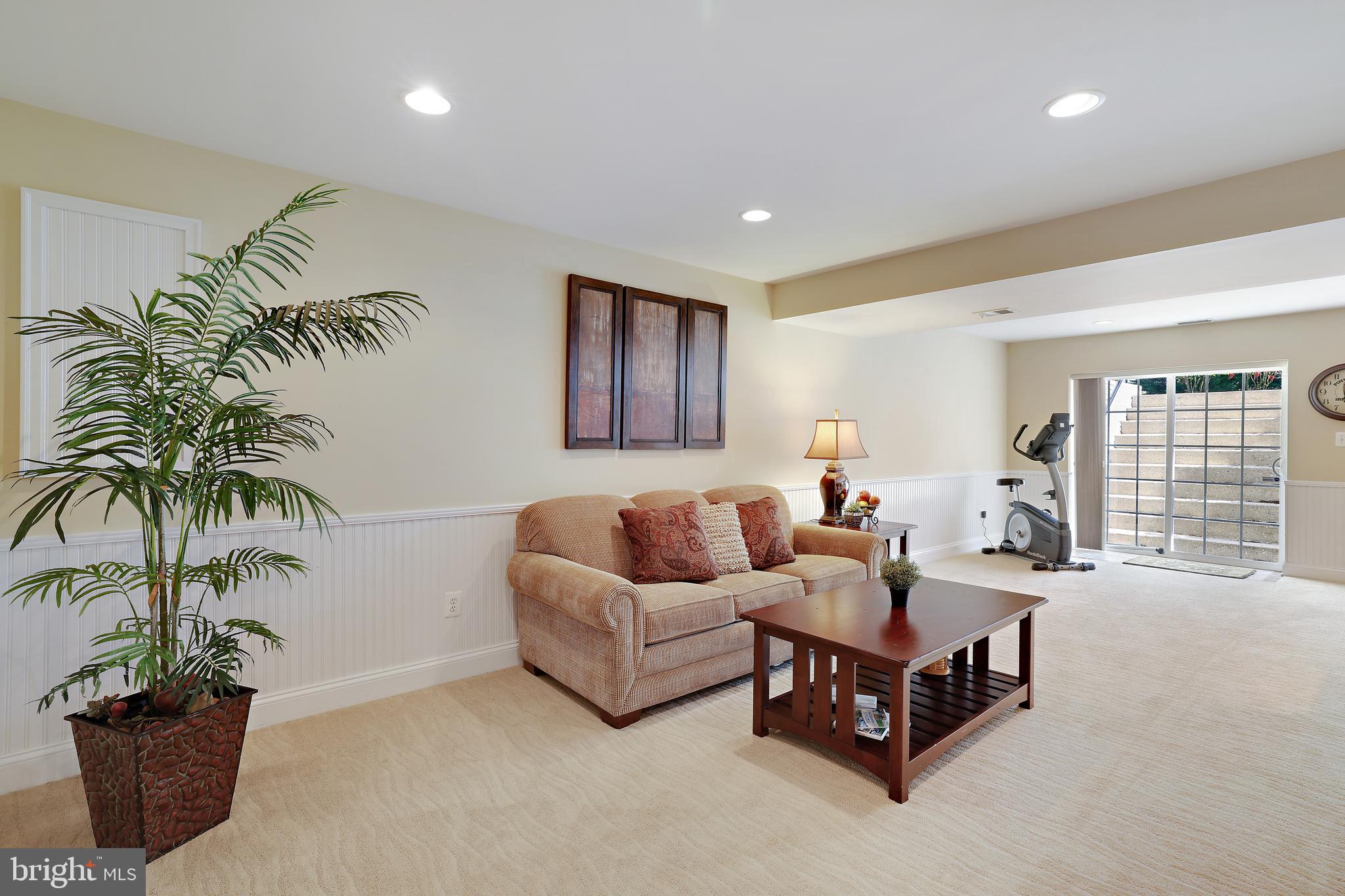 8301 Banister Road Severn, MD 21144 - Photo 9 of 57 a living room with furniture potted plant and a window