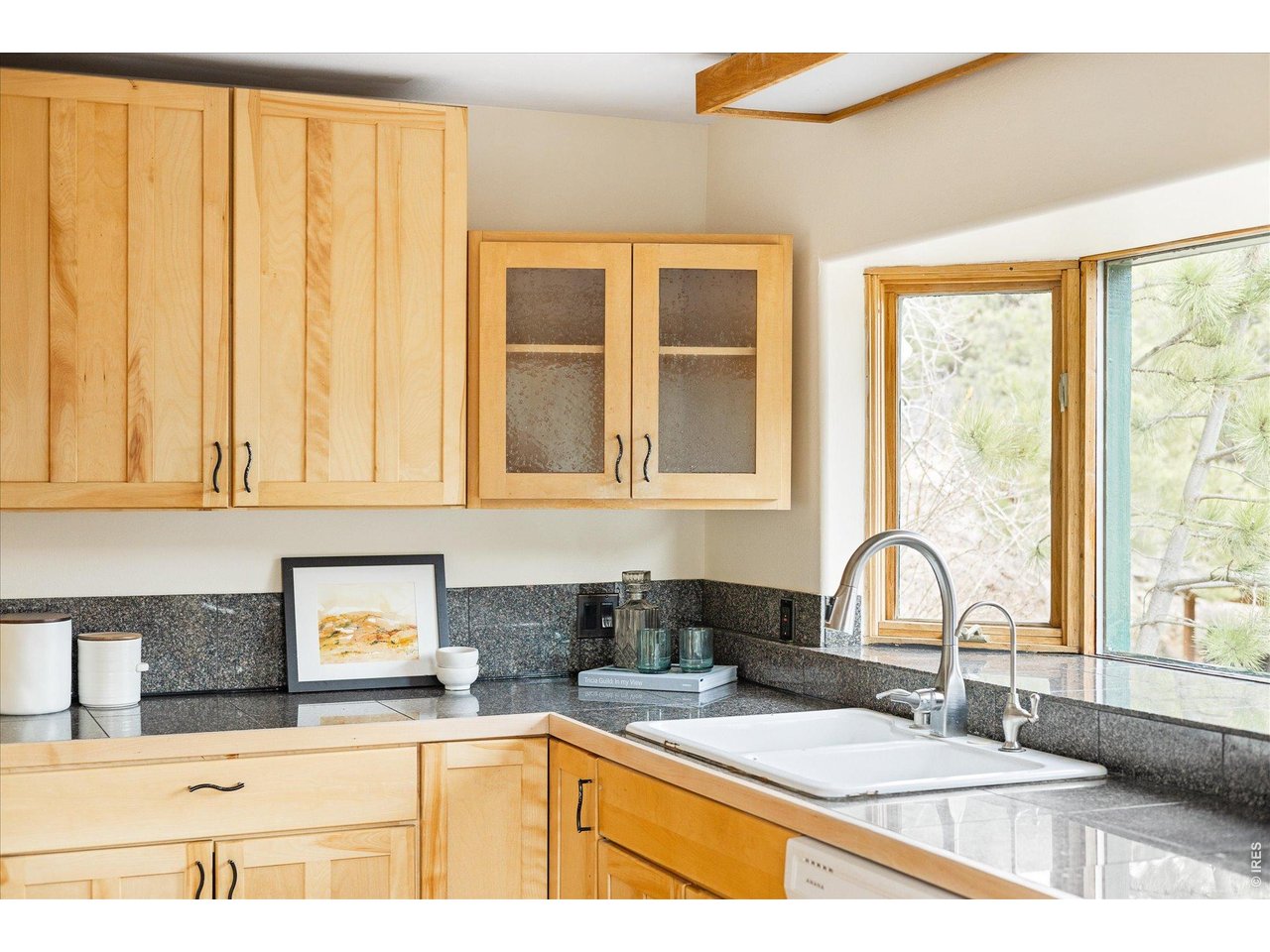 187 Nugget Hill Road Jamestown, CO 80455 - Photo 10 of 34 a kitchen with granite countertop a sink a counter and cabinets