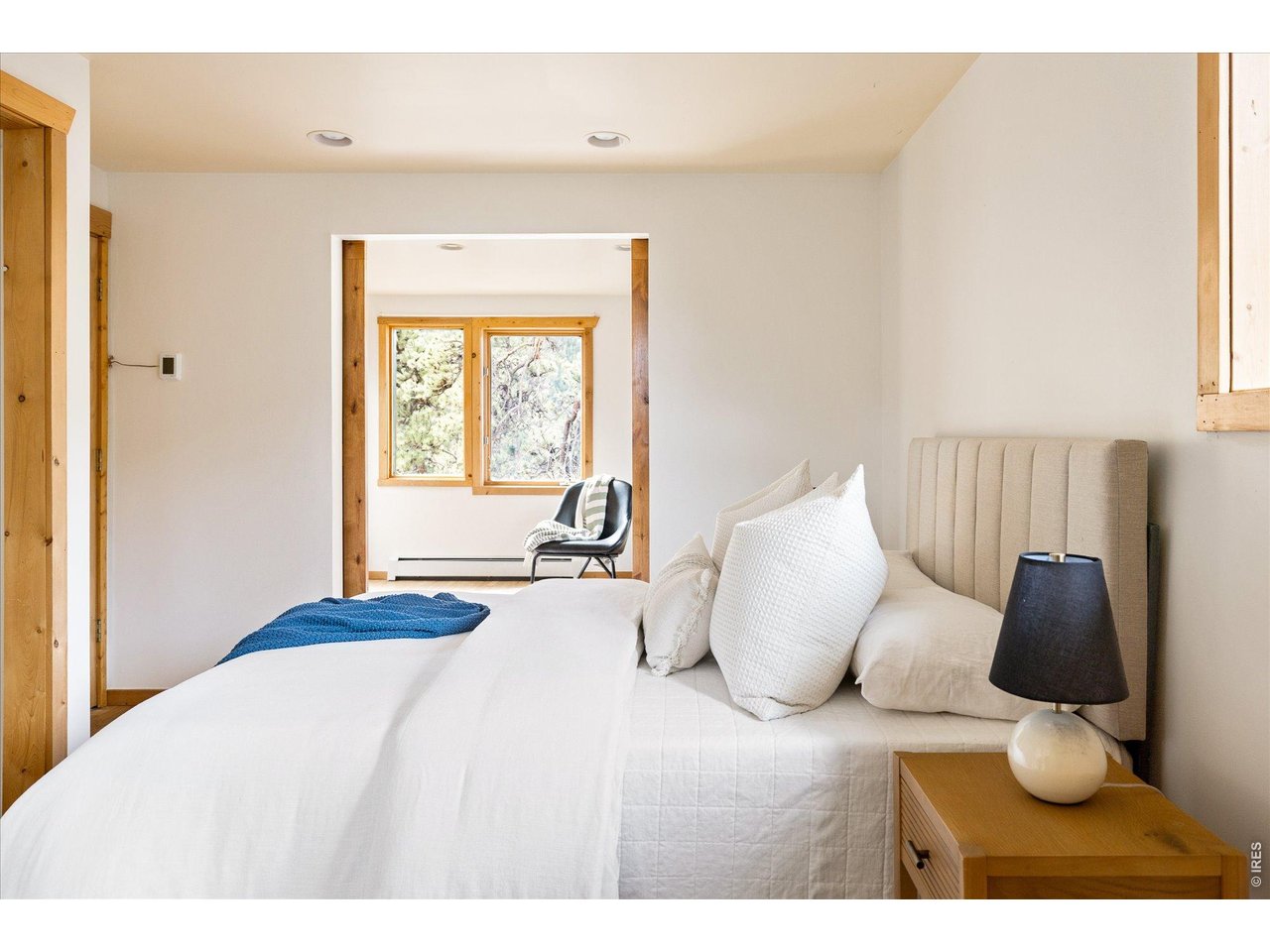 187 Nugget Hill Road Jamestown, CO 80455 - Photo 13 of 34 a bedroom with a bed and wooden floor