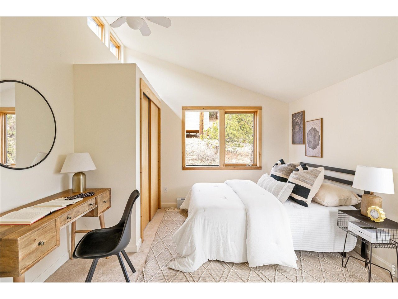 187 Nugget Hill Road Jamestown, CO 80455 - Photo 22 of 34 a bed room with a bed a mirror and a window