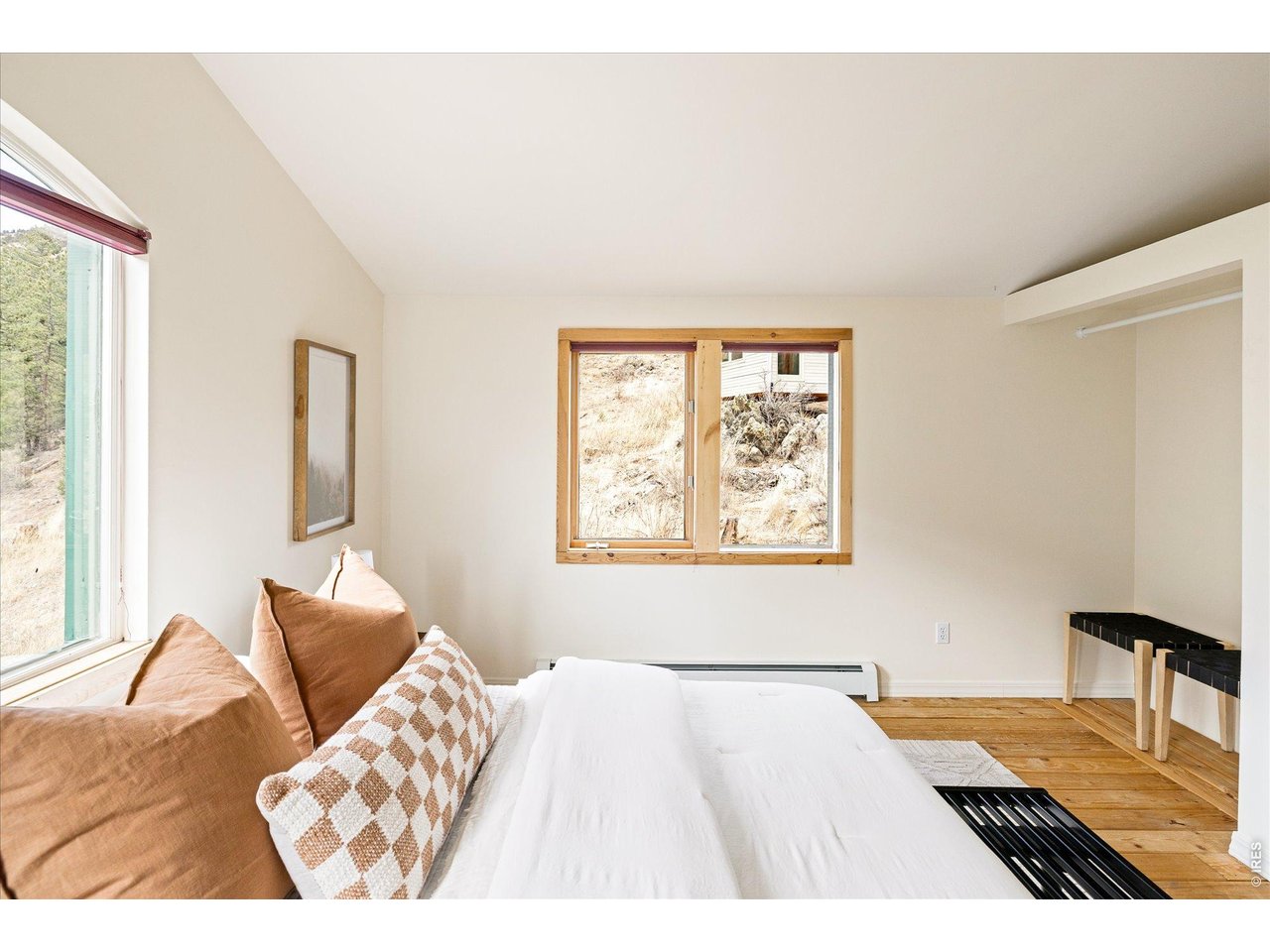 187 Nugget Hill Road Jamestown, CO 80455 - Photo 23 of 34 a bedroom with a bed and wooden floor