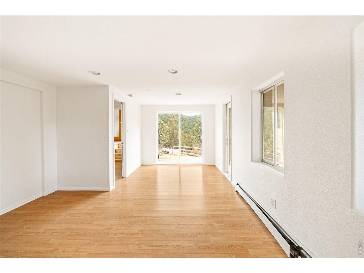 187 Nugget Hill Road Jamestown, CO 80455 - Photo 28 of 34 a view of an empty room with wooden floor and a window