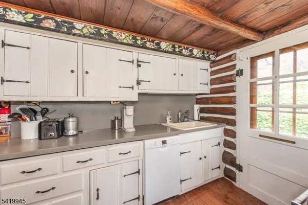 a kitchen with a sink window and cabinets