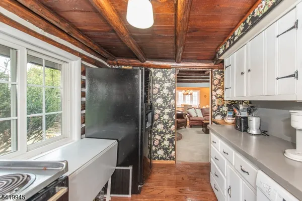 a kitchen with sink refrigerator and window