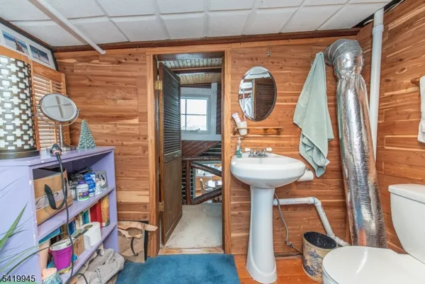 a bathroom with a toilet a sink and a mirror