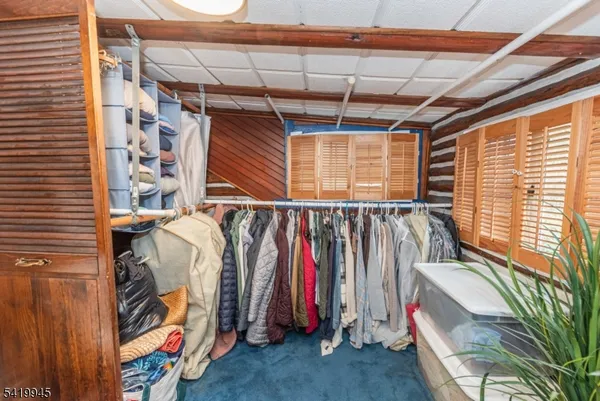 a view of walk in closet with clothes