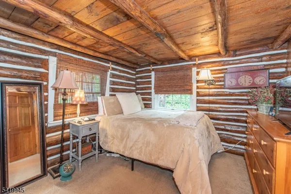a bedroom with furniture and large windows