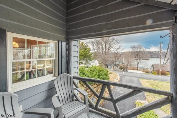 a view of a living room and balcony with furniture