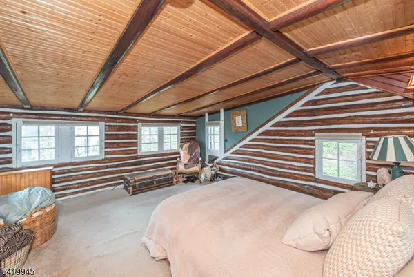 a bedroom with bed and a large window
