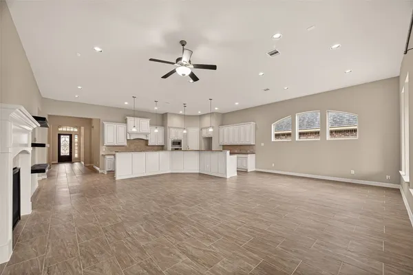 a large kitchen with cabinets and wooden floors