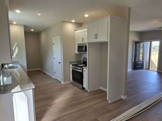 a kitchen with stainless steel appliances granite countertop a refrigerator and a sink
