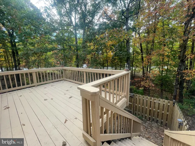 a view of balcony with wooden floor and fence