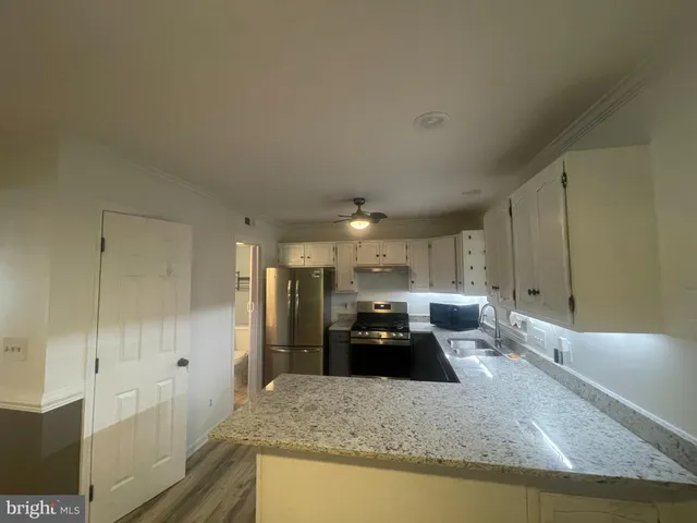 a stove top oven sitting inside of a kitchen