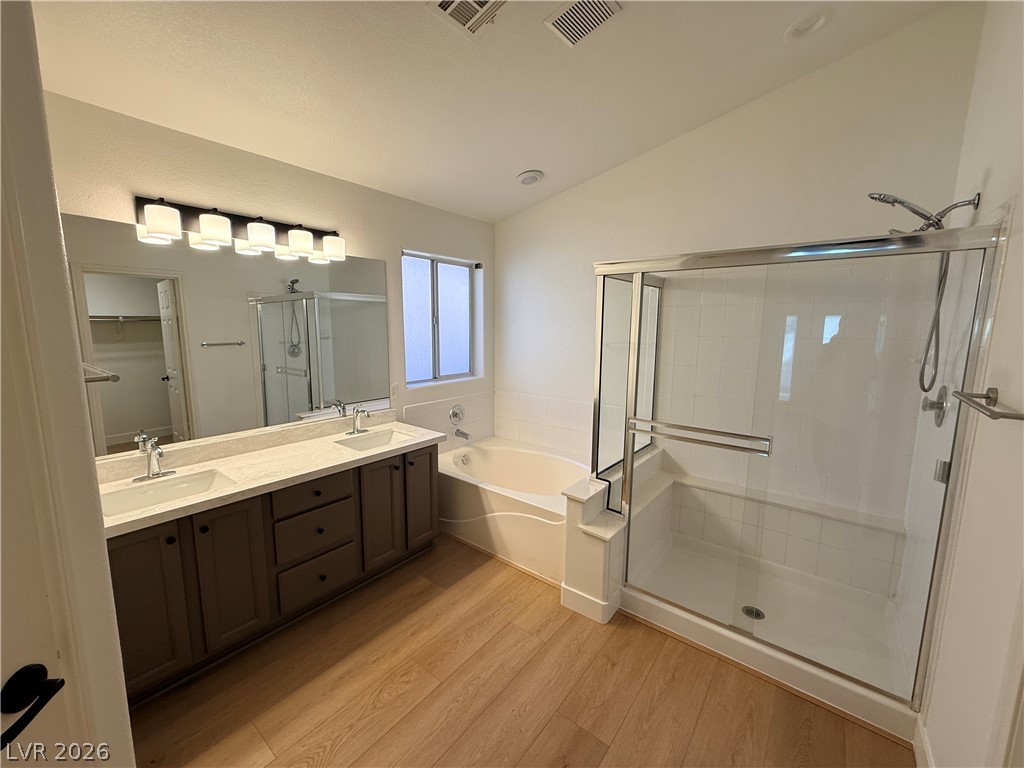 2122 Hidden Ranch Terrace Henderson, NV 89052 - Photo 17 of 20 A tranquil primary bathroom featuring a dual-sink vanity and a spacious walk-in shower.