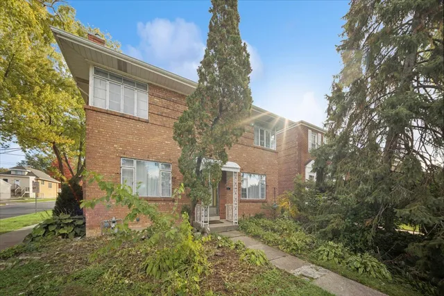 a tree in front of a house