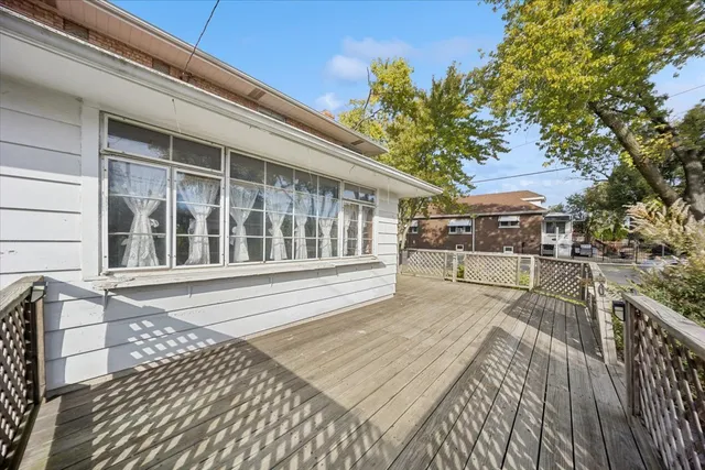 a view of a balcony with wooden floor and seating space