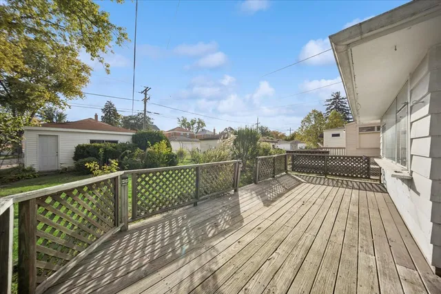 a view of balcony with wooden floor and fence