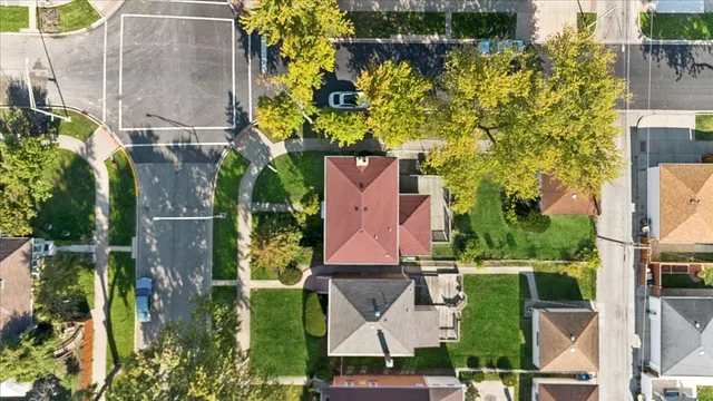 an aerial view of a house with a yard basket ball court and outdoor seating