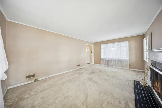 a view of an empty room with a fireplace