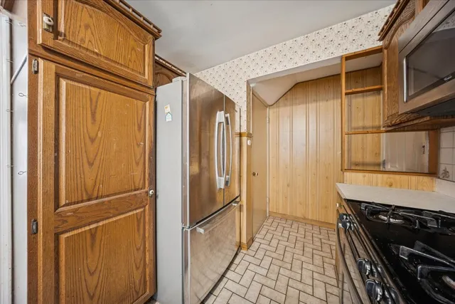 a kitchen with a refrigerator and a stove