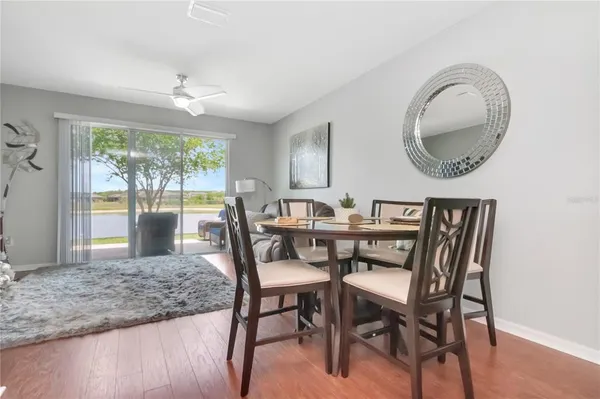 a view of a dining room with furniture wooden floor and chandelier