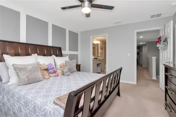 a bedroom with a bed and ceiling fan
