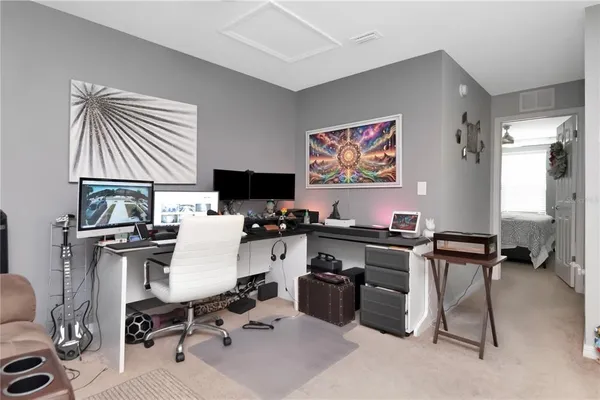 a view of a workspace with furniture and a window