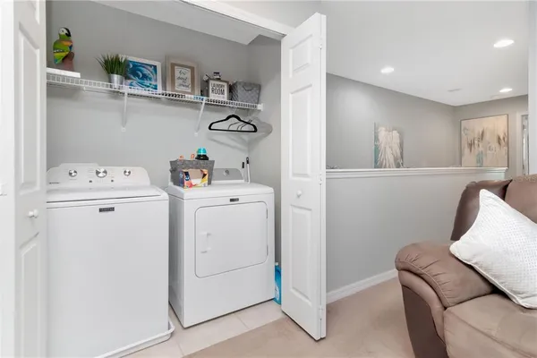 a bathroom with a granite countertop toilet sink and mirror