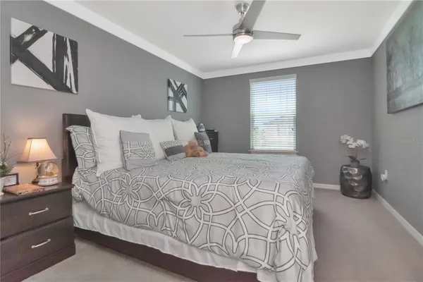 a bedroom with a large bed and a chandelier