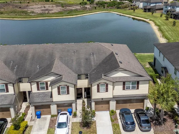 an aerial view of a house with swimming pool and outdoor seating