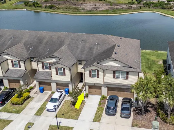 an aerial view of a house with a ocean
