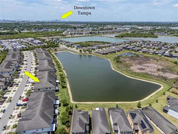 an aerial view of a residential houses with outdoor space and swimming pool