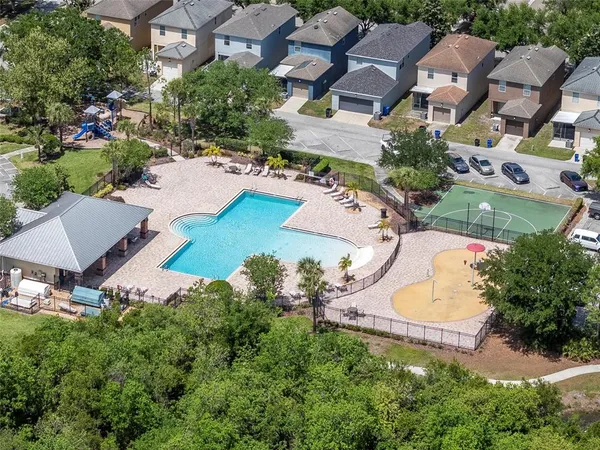 an aerial view of a house with a swimming pool yard and outdoor seating