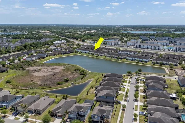 an aerial view of a house with a yard