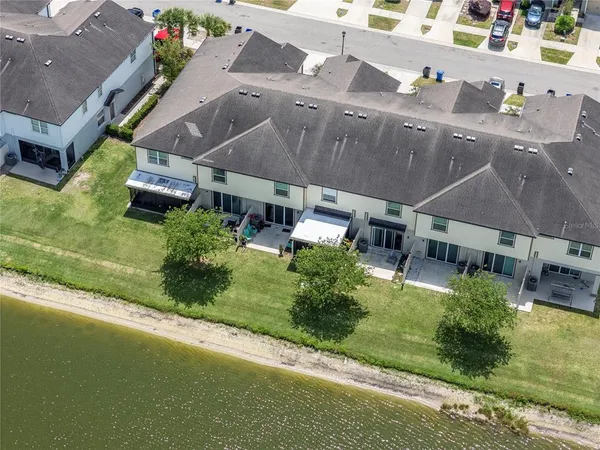 an aerial view of residential houses with outdoor space and river