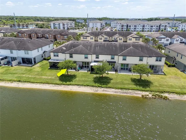 an aerial view of residential houses with outdoor space and river view