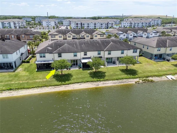 an aerial view of a house with a yard