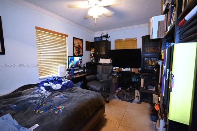 a bedroom with a bed a window and gym equipment