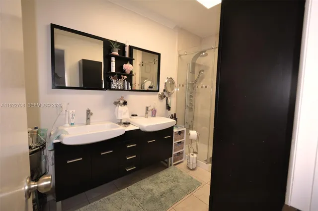 a bathroom with a double vanity sink and mirror
