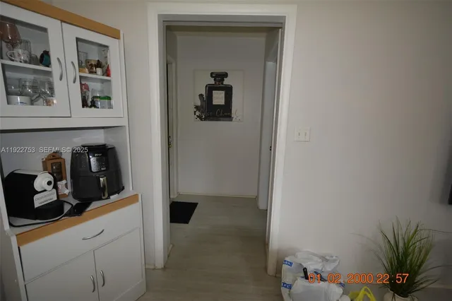 a kitchen with a refrigerator and cabinets