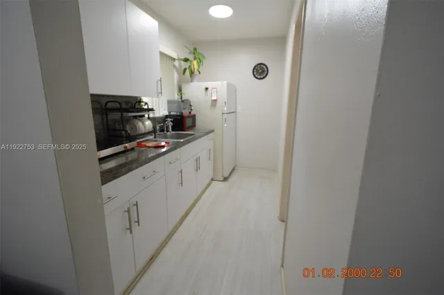 a kitchen with stainless steel appliances a refrigerator and a stove