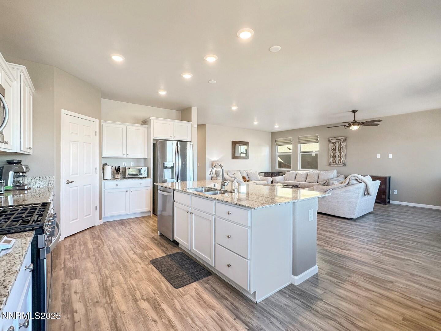 2015 Painted Sky Way Sun Valley, NV 89433 - Photo 14 of 31 a kitchen with sink refrigerator and cabinets