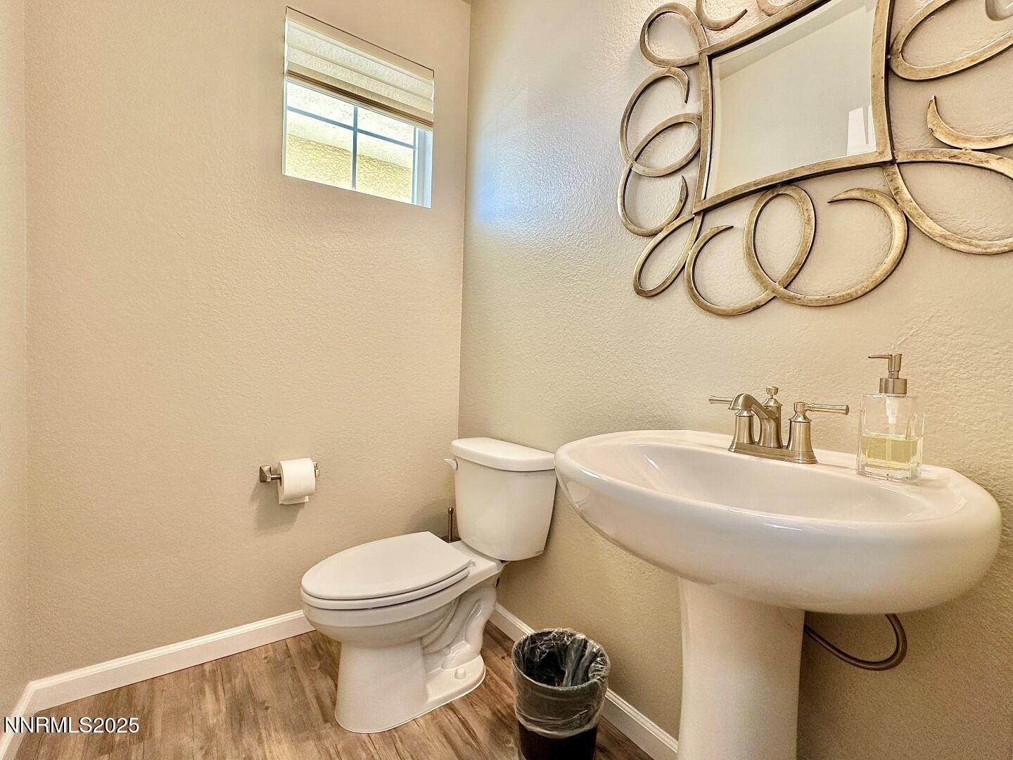 2015 Painted Sky Way Sun Valley, NV 89433 - Photo 15 of 31 a bathroom with a sink a toilet and a mirror