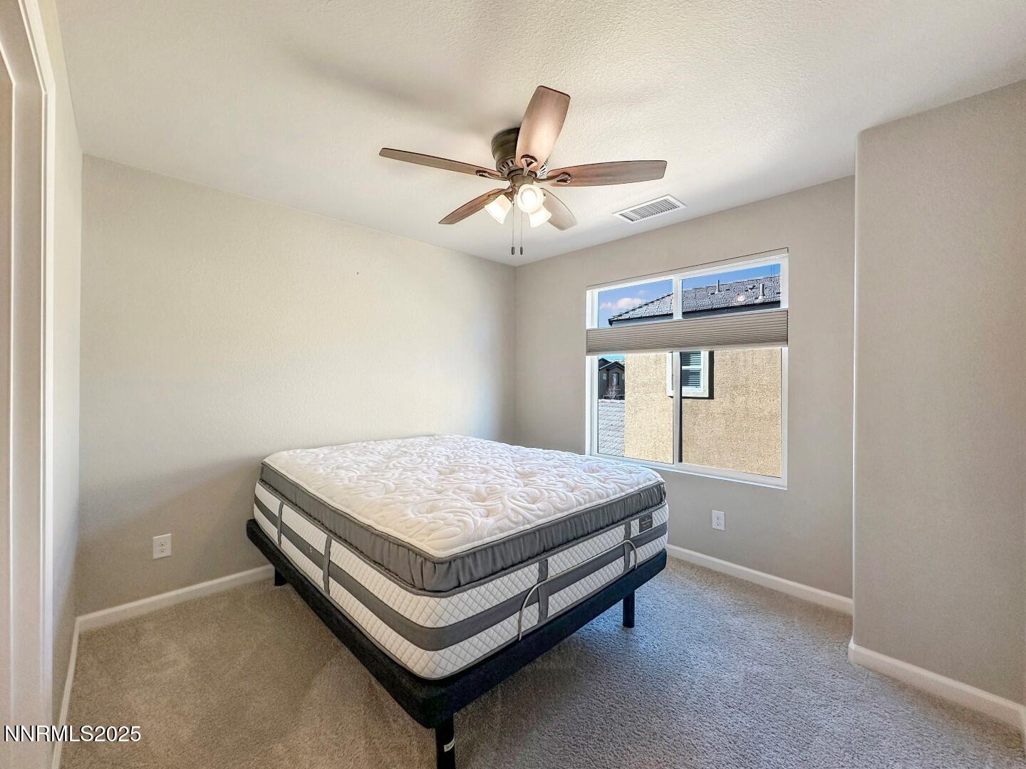 2015 Painted Sky Way Sun Valley, NV 89433 - Photo 25 of 31 a bedroom with a bed and window