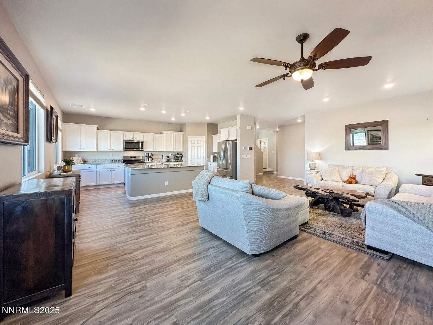 2015 Painted Sky Way Sun Valley, NV 89433 - Photo 3 of 31 a living room with couches and kitchen view with wooden floor