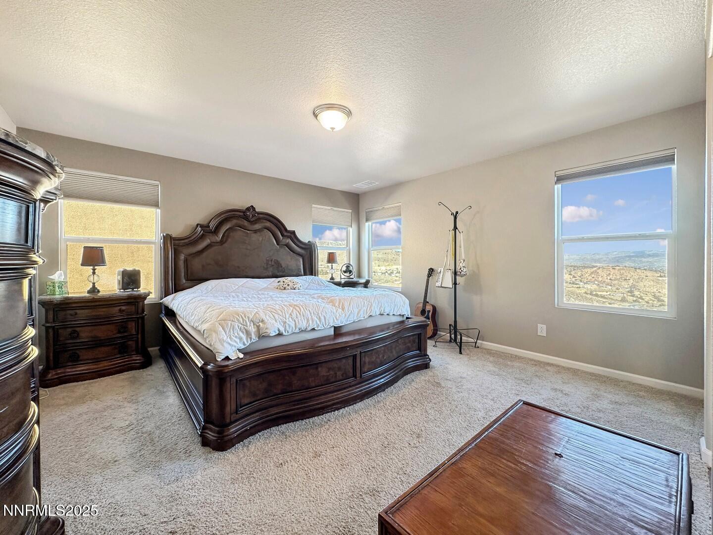 2015 Painted Sky Way Sun Valley, NV 89433 - Photo 7 of 31 a bedroom with a bed and wooden floor