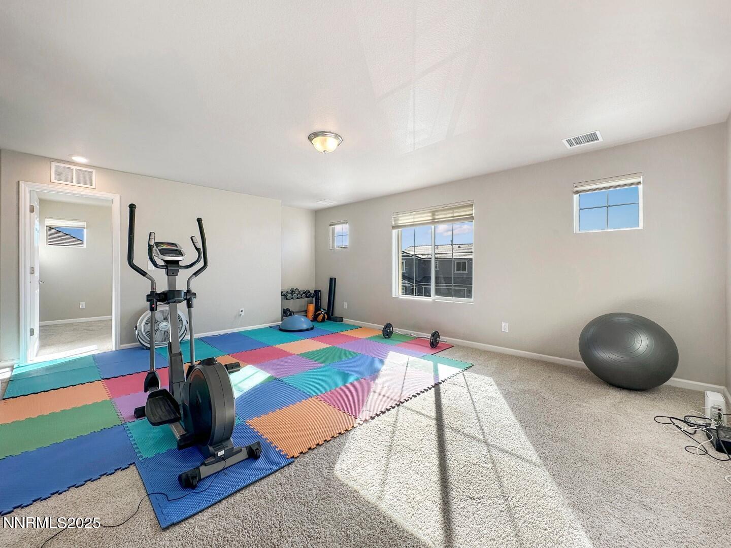2015 Painted Sky Way Sun Valley, NV 89433 - Photo 8 of 31 a room with gym equipment and a table