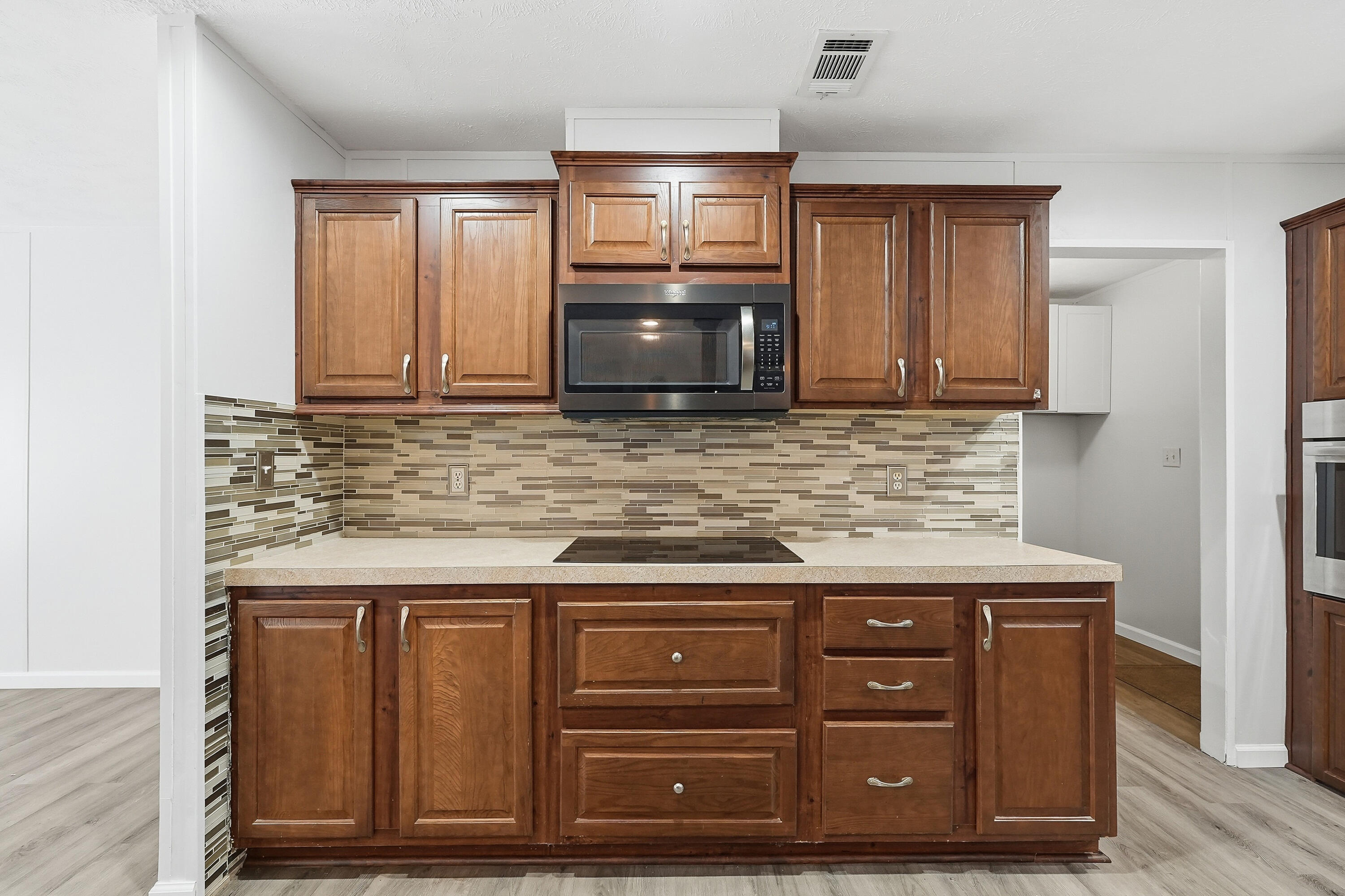 482 Roberts Road East DeFuniak Springs, FL 32433 - Photo 12 of 61 a kitchen with granite countertop a stove microwave and cabinets